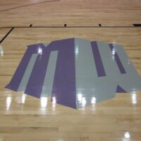 Logo in wooden flooring of gymnasium | Pryor Floor