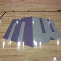 Logo in wooden flooring of gymnasium | Pryor Floor